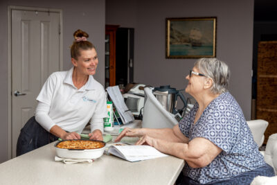 An aged care worker in Brisbane assists a client