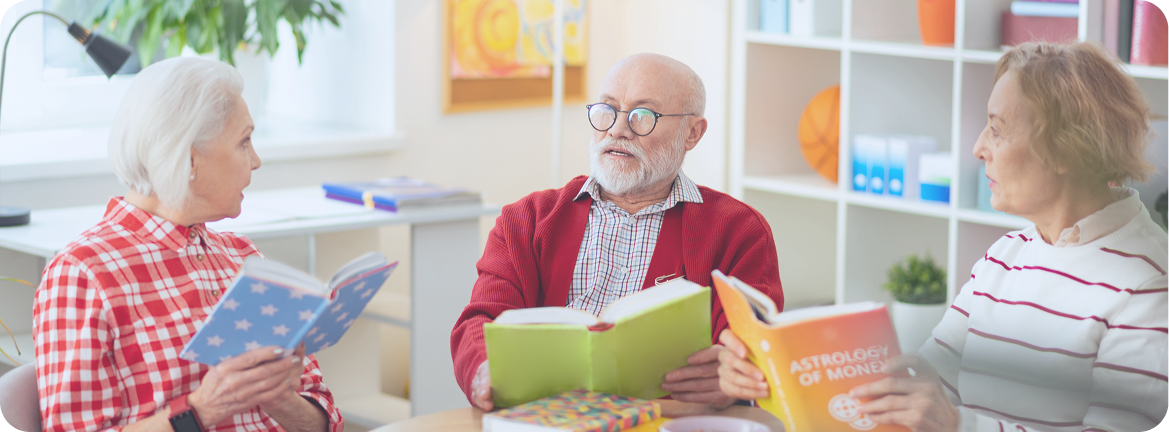 A group of older Australians reading books and discussing their favourite things to do for seniors in Melbourne.