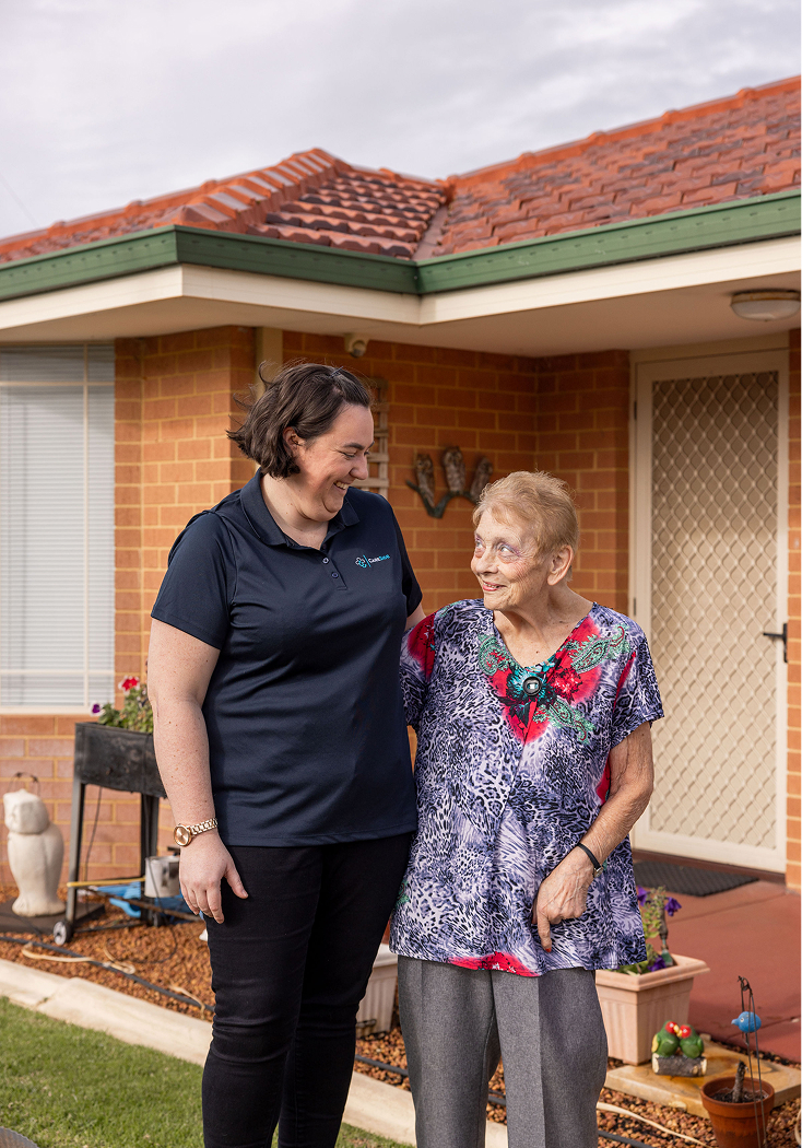 A photo of a home care recipient in Geelong smiling at her caregiver from The CareSide while they enjoy time outside.