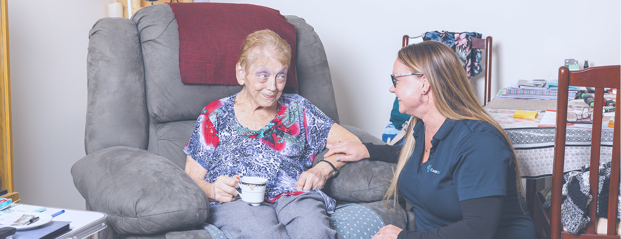 A home care recipient discusses home care package wait times with her caregiver.