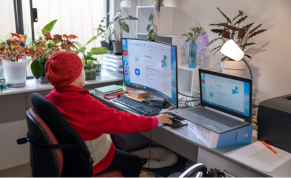 A photo of a home care applicant on a computer researching Home Care Package wait times.