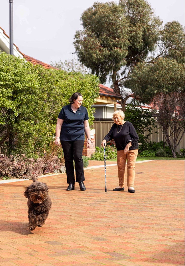 A caregiver delivers the best home care in Port Macquarie while accompanying an NSW aged care client on a walk.