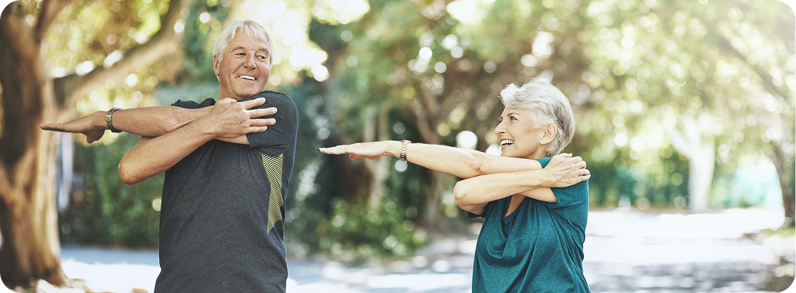 Exercise classes are one of the most popular things to do for seniors in Brisbane. In this photo, two older Australians smile while enjoying an outdoor yoga class.