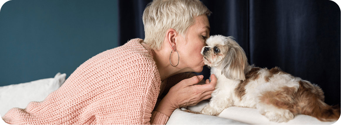 Pets can help with healthy ageing, and in this photo, an older woman is seen snuggling with her dog.