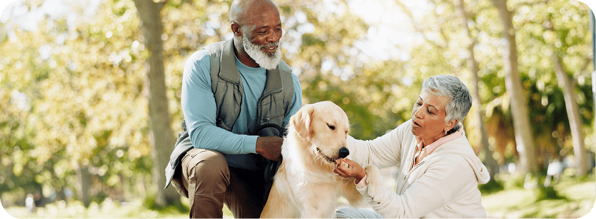 A photo of two older people and their dog. Pets and animals can play an important role in healthy ageing.