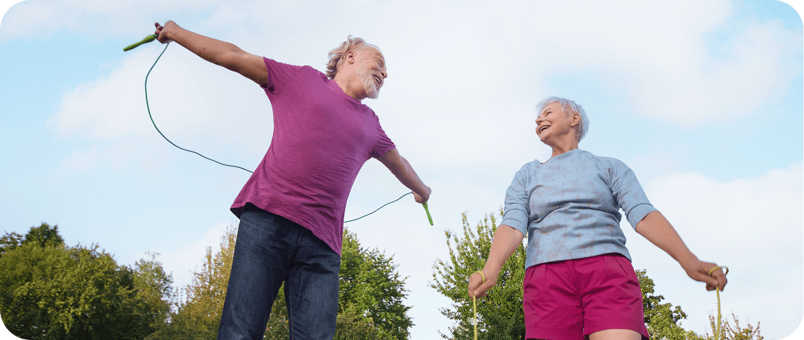 Photo of two super agers exercising outside. 