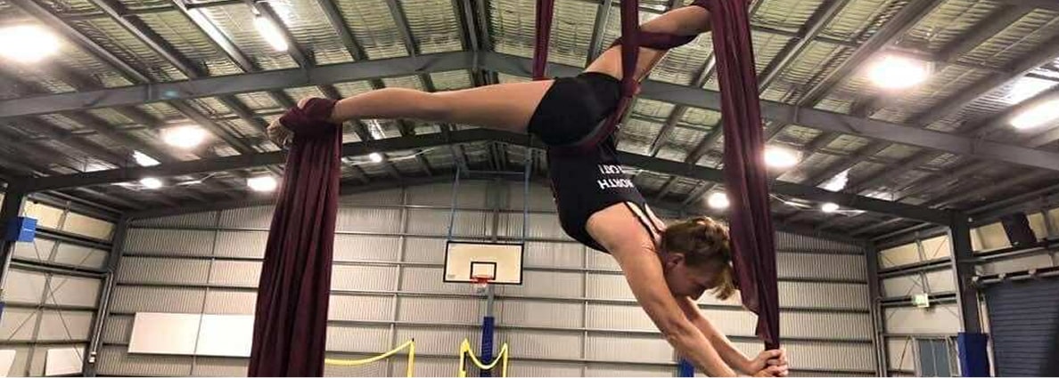 Super Senior Julie uses silks to perform acrobatic stunts.